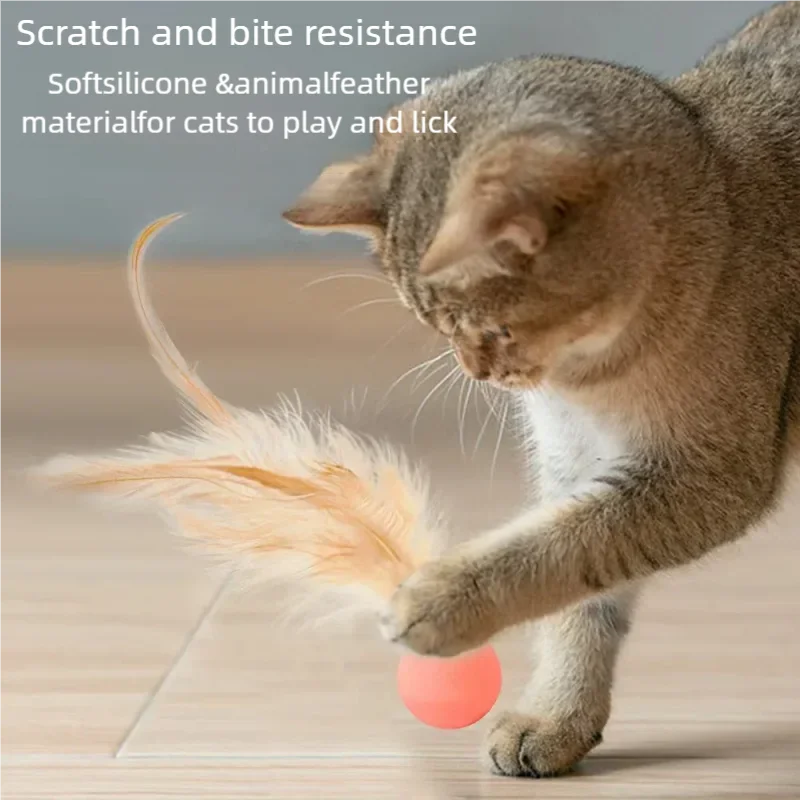 A tabby cat plays with an orange ball and a feather toy on a wooden floor.
