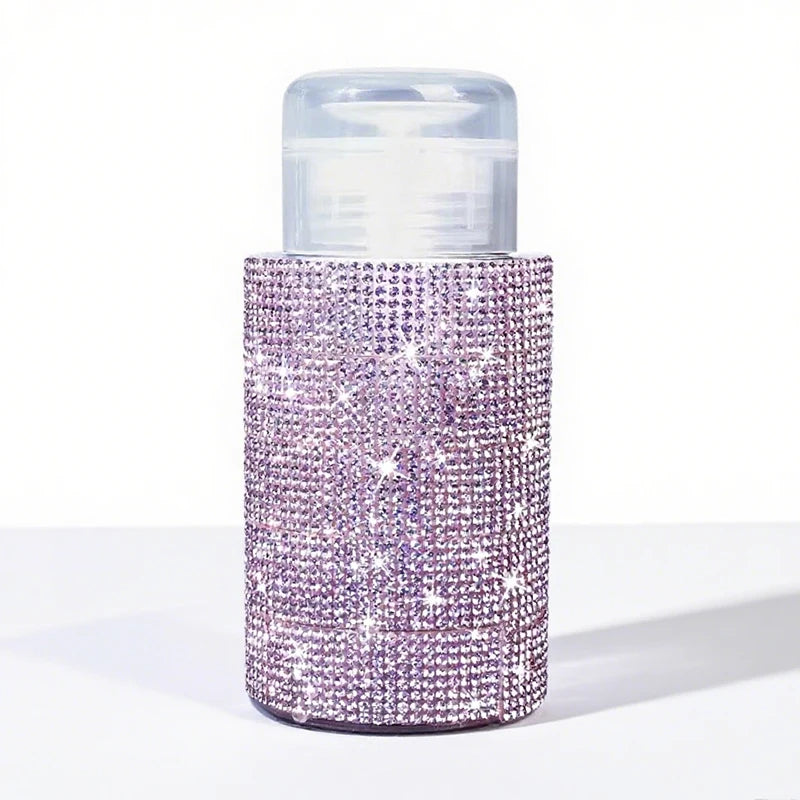 A purple, glittery refillable pump bottle with a clear cap for nail polish remover or makeup.