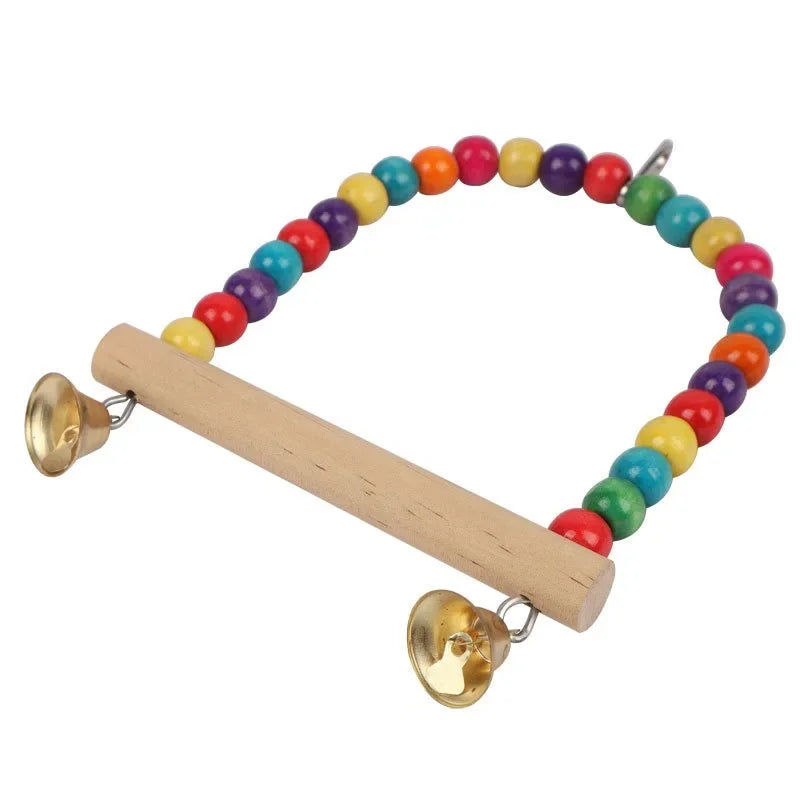 A wooden bird swing featuring a colorful beaded necklace and hanging bells.