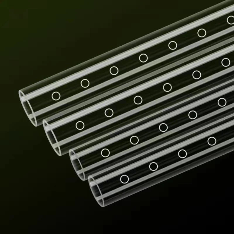 A close-up view of a transparent acrylic aquarium spray bar with multiple parallel nozzles.
