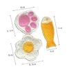 A set of natural loofah cat chew toys, including a pink paw print and an orange fish shape.