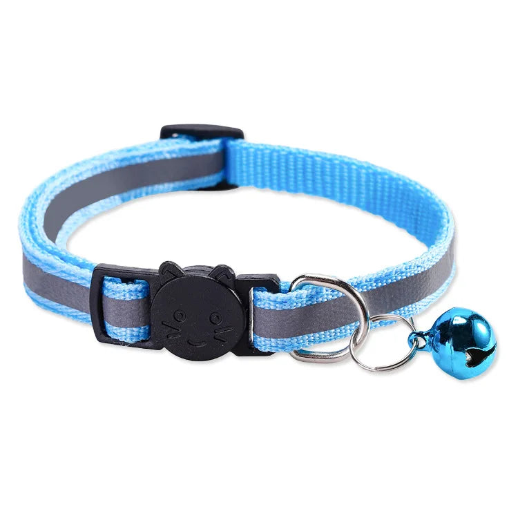 A blue and gray reflective nylon pet collar with a silver bell attached.