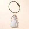 Figurine en verre clair d'un chat blanc à marques noires, attachée à une clé USB en cuir tressé.