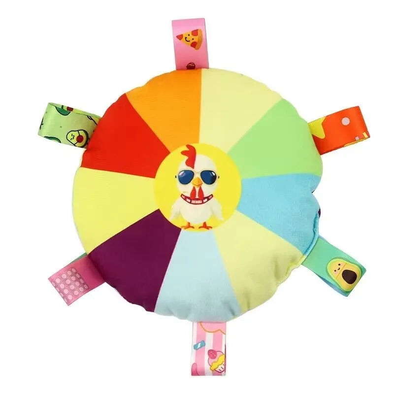 A colorful, round plush dog toy shaped like a flying disc with a yellow and rainbow pattern.