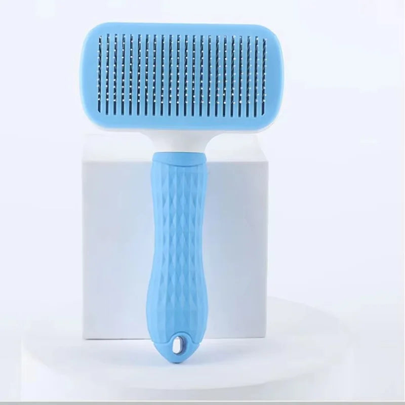 A light blue pet slicker brush with a white base is shown against a white background.