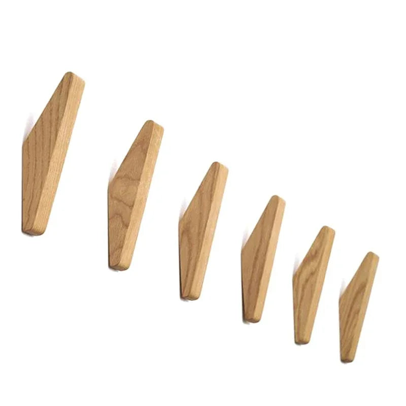 A set of three wooden triangle coat hooks made of oak wood.