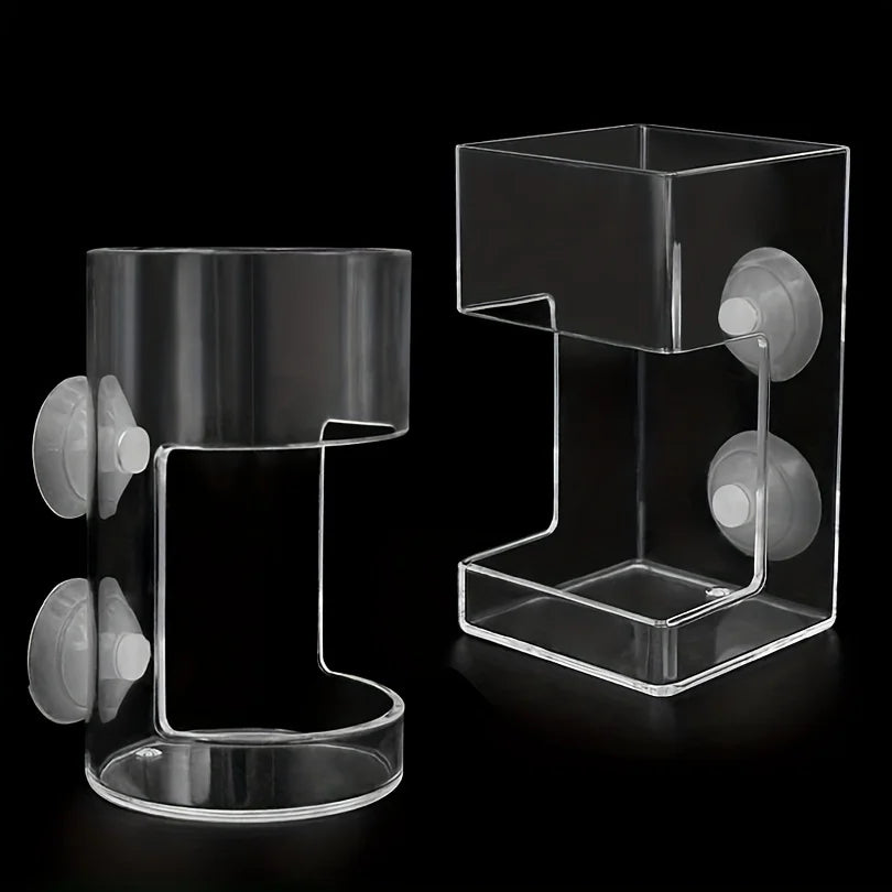 Clear acrylic aquarium fish feeder ring with a rectangular tray and feeding holes.