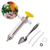 A clear plastic syringe with a yellow tip and a metal spoon for feeding parrots, shown next to a bird.