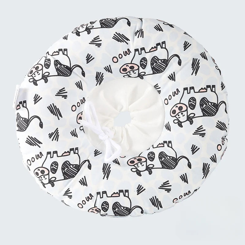A white soft cotton recovery collar for dogs and cats featuring a pattern of cartoon animals.
