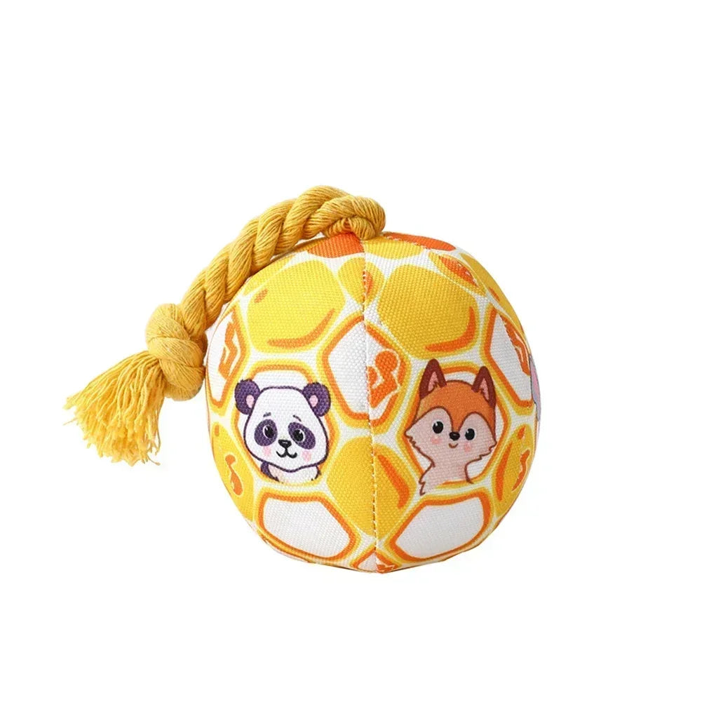 Yellow hexagonal plush ball toy with panda and fox faces, tied with a golden rope.