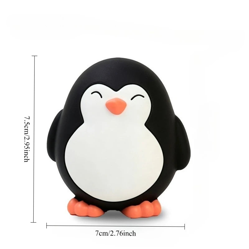 A cute penguin dog toy with black and white coloring and orange feet.
