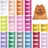 A variety of multi-color dog hair clips in various shades are displayed, ready for pet grooming.
