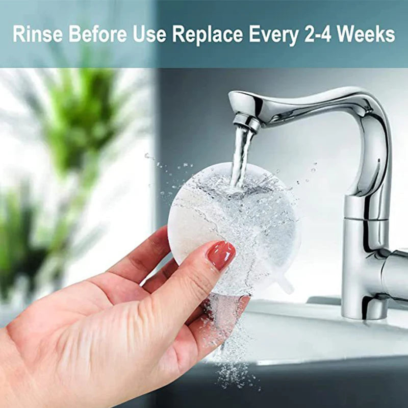 A hand is rinsing a silver faucet with water, demonstrating the need to replace filters every 2-4 weeks.