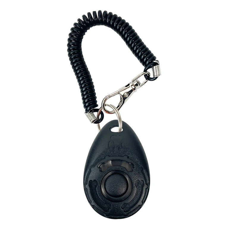 Clicker ergonomique noir pour entraîner les chiens avec une sangle de poignet enroulée.