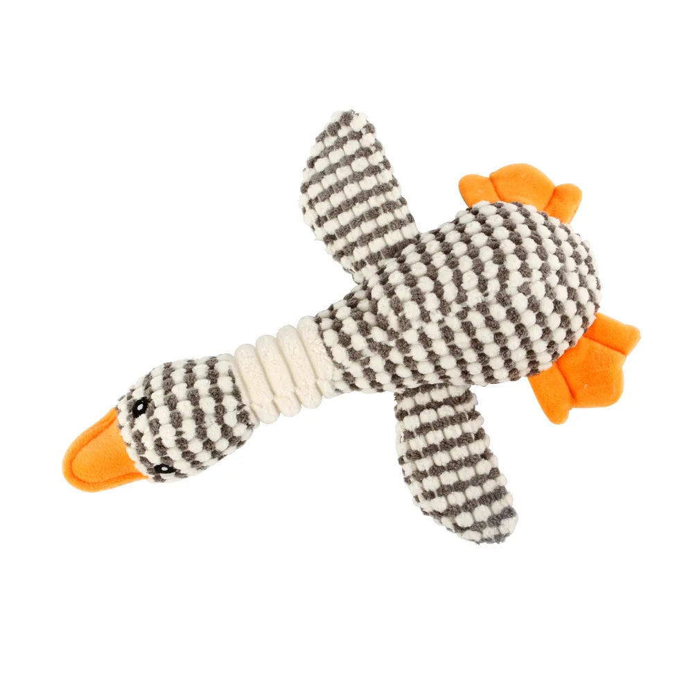 An animal-shaped squeaky dog toy with a corduroy cover, featuring gray and white patterned fabric and orange accents.