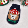A knitted winter dog sweater featuring a brown bear face with a red hat and green collar.