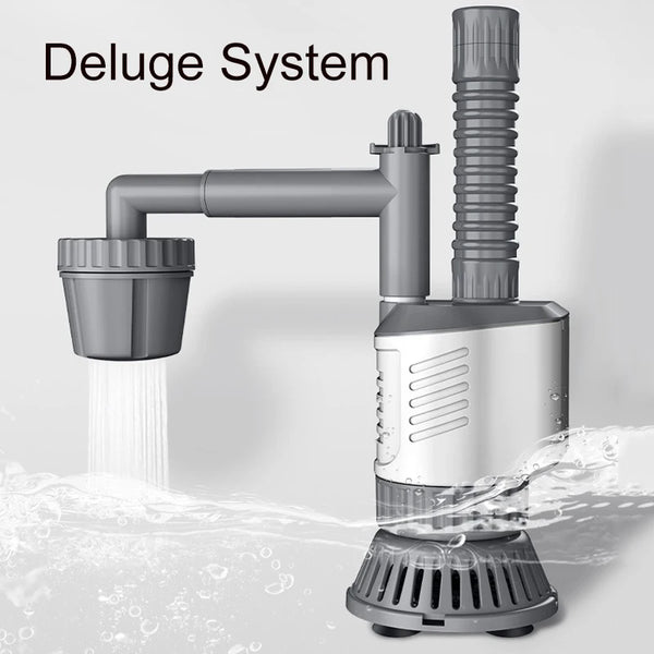 A silver deluge system pump is shown pouring water into a tank, creating splashing waves.