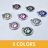 Eight colored personalized paw print pet ID tags with various glitter finishes and metal rings.