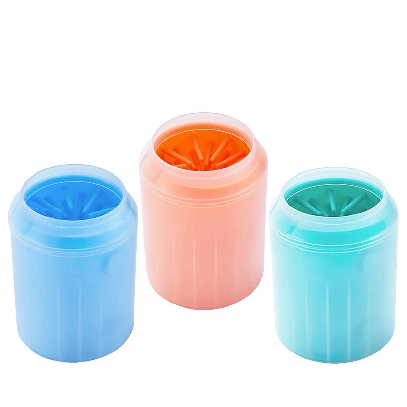 Three plastic cups for washing pets with soft silicone bristles in blue, pink, and teal colors