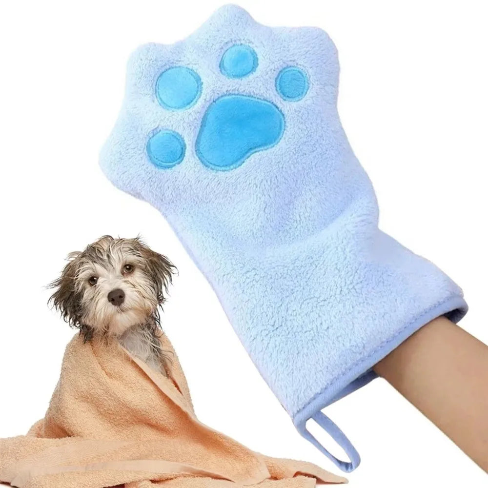 Light blue pet grooming glove with a paw print design worn by a dog.