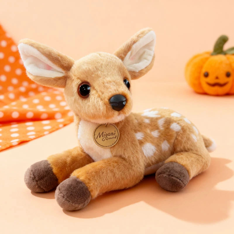 A soft plush stuffed animal toy resembling a fox or canine with light brown fur and white markings.