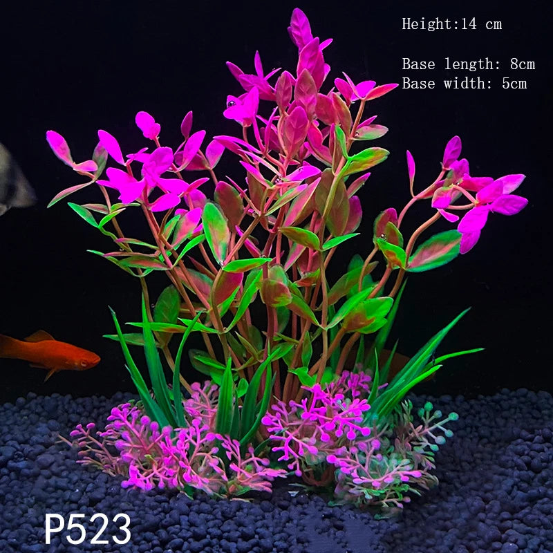 A vibrant artificial aquarium plant with pink and magenta flowers and green leaves growing from a dark substrate.