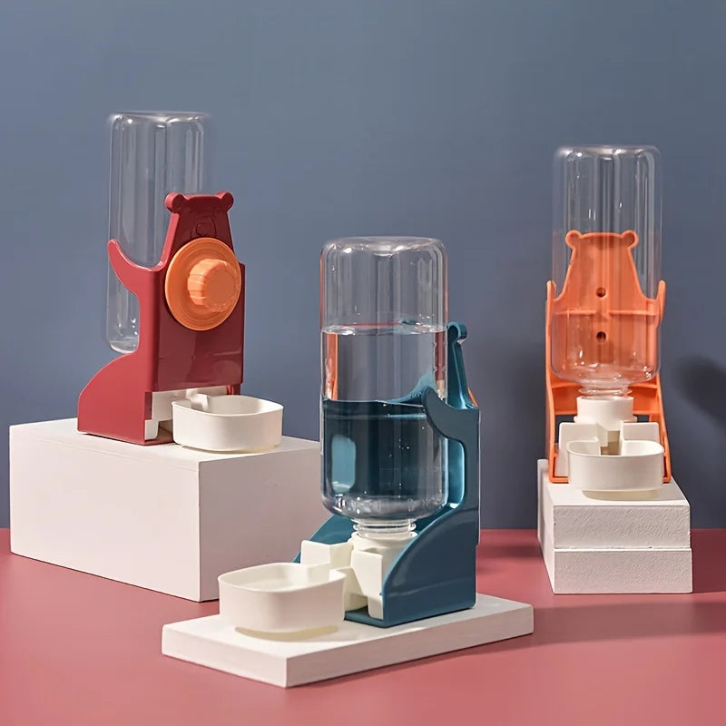 A set of three No-Drip hanging water bottles for small pets in shades of red, orange, and blue on white display stands.