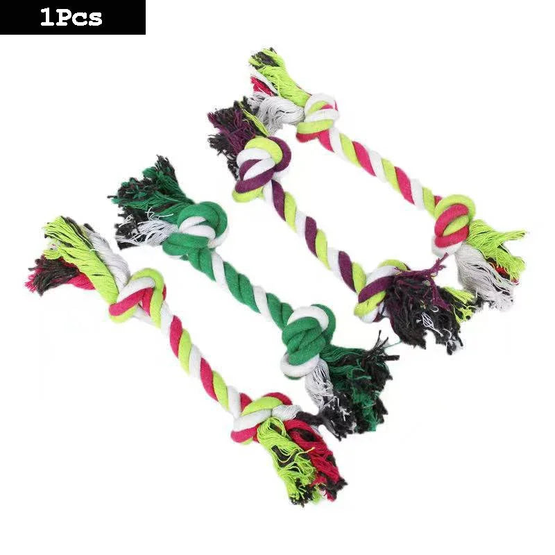 A set of interactive cotton rope dog toys shaped like a carrot and dumbbell, featuring green, pink, and white fibers.