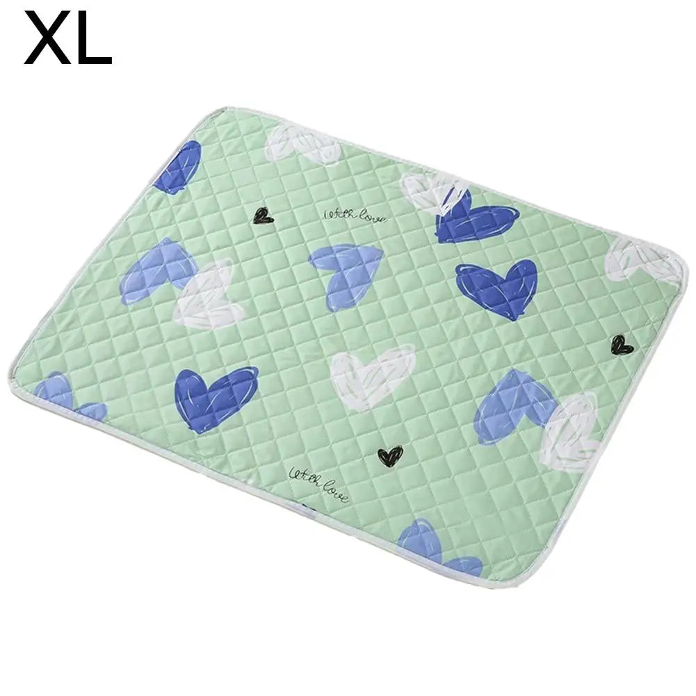 A green quilted pet urine pad featuring a pattern of blue and white hearts.