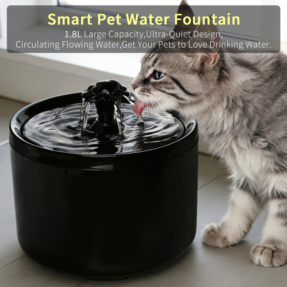A tabby cat is drinking water from a black smart pet water fountain bowl.