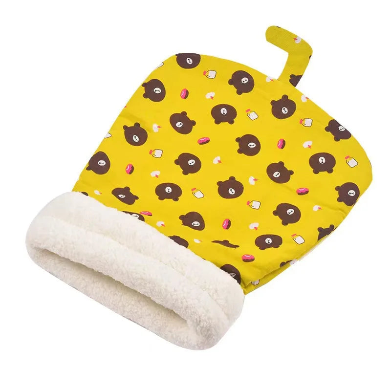 Yellow fabric cat bed with brown paw print patterns and a white sherpa lining.
