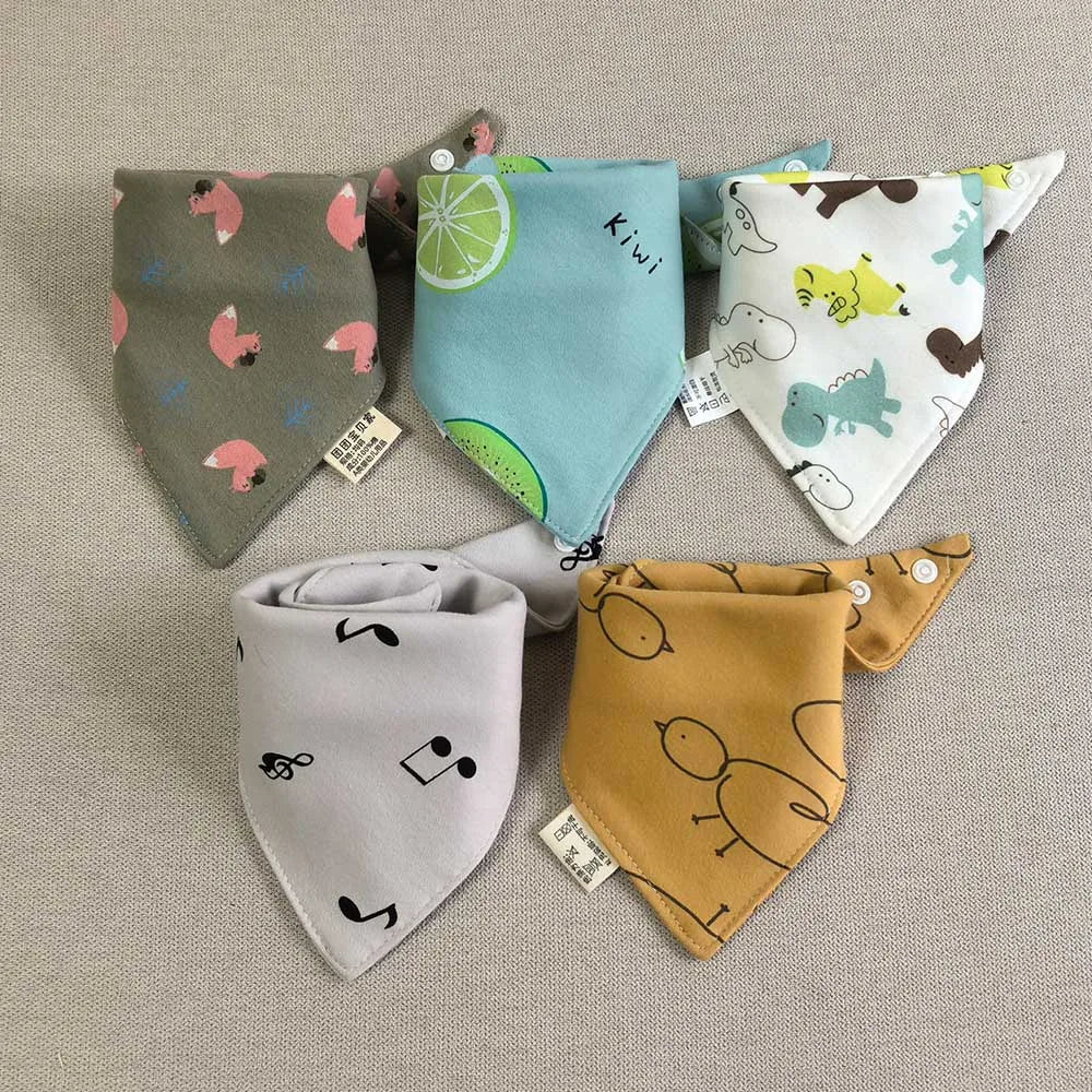 A set of five cotton triangle baby bibs featuring various cartoon prints including kiwi, elephants, and other animals.