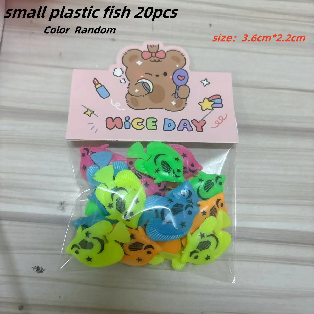A clear plastic bag contains ten small, colorful rubber goldfish bath toys for kids.