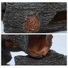 Close-up view of a hollowed tree branch used as an aquarium ornament, showing the natural wood texture and opening.