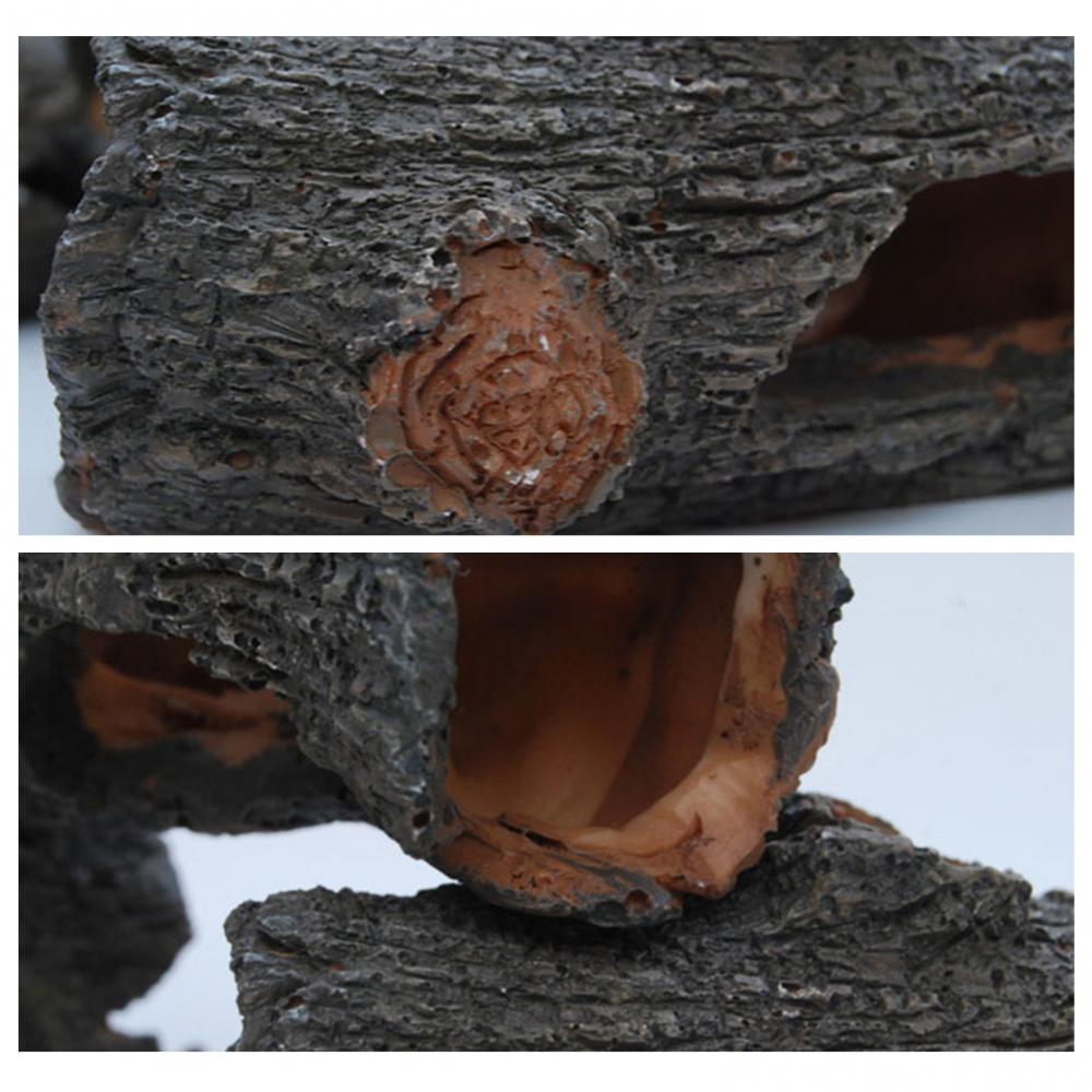 Close-up view of a hollowed tree branch used as an aquarium ornament, showing the natural wood texture and opening.