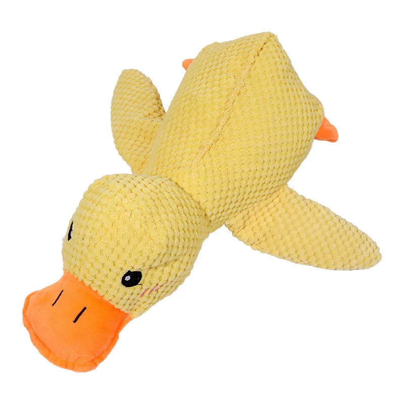 A soft yellow plush toy shaped like a duck with an orange beak and feet.