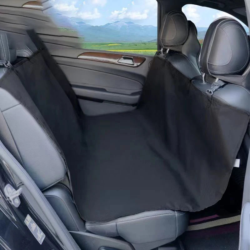 Interior view of a car showing a black waterproof dog car seat hammock installed in the rear passenger seat.