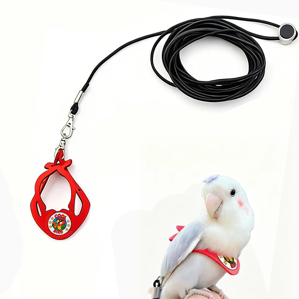A red adjustable parrot harness and elastic leash set with a black cord and a white bird.