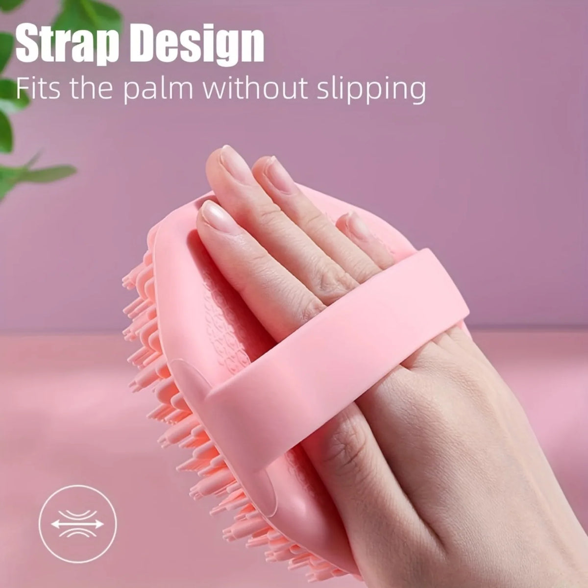 A hand is holding a pink silicone body exfoliating brush, demonstrating its grip design.