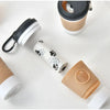 A collection of portable pet poop trash can dispensers in beige and white colors.