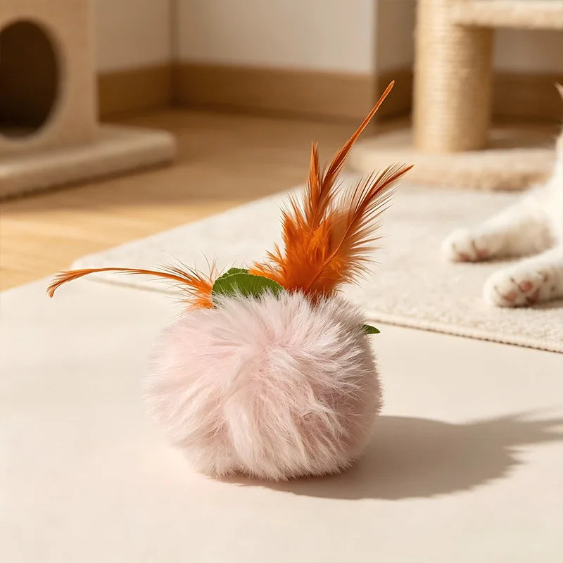 A fluffy pink ball with orange feathers, part of an interactive cat toy set.