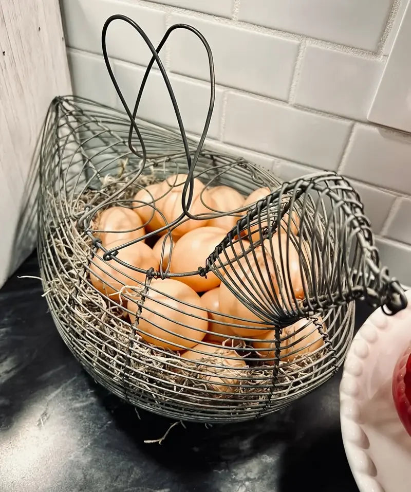 A woven wire basket filled with brown chicken eggs on a dark surface.