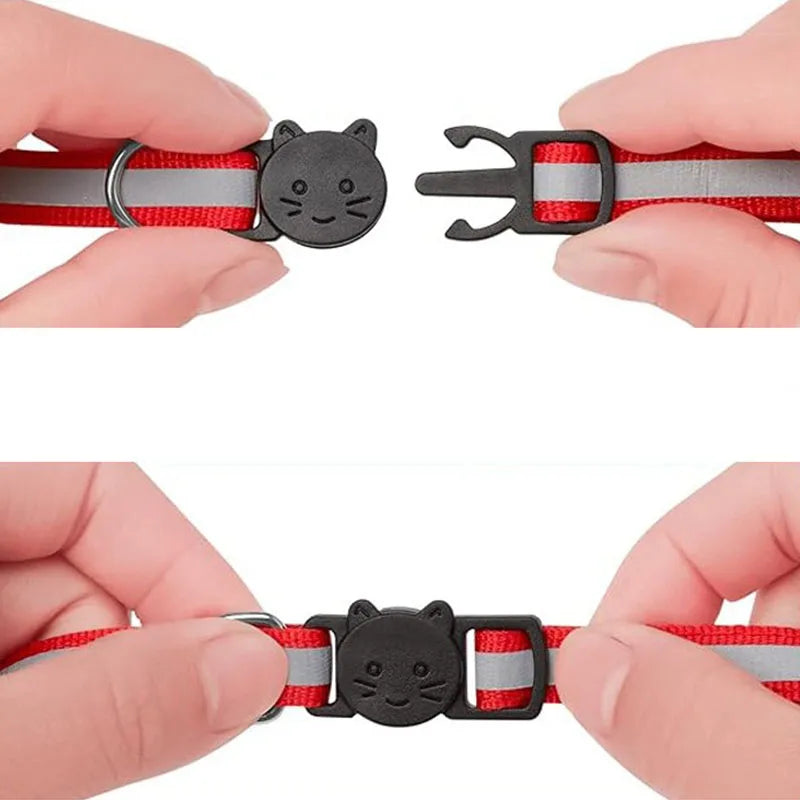 A safety breakaway cat collar in red and gray with a black cat charm being held by a hand.