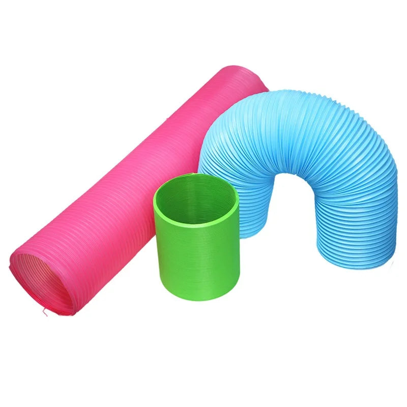 Three colored plastic tunnels, pink, green, and blue, used for small pet activity.