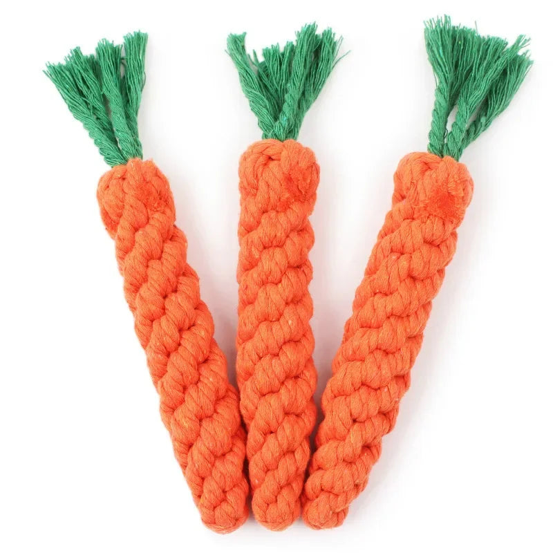 Three orange cotton rope toys shaped like carrots with green fibers.