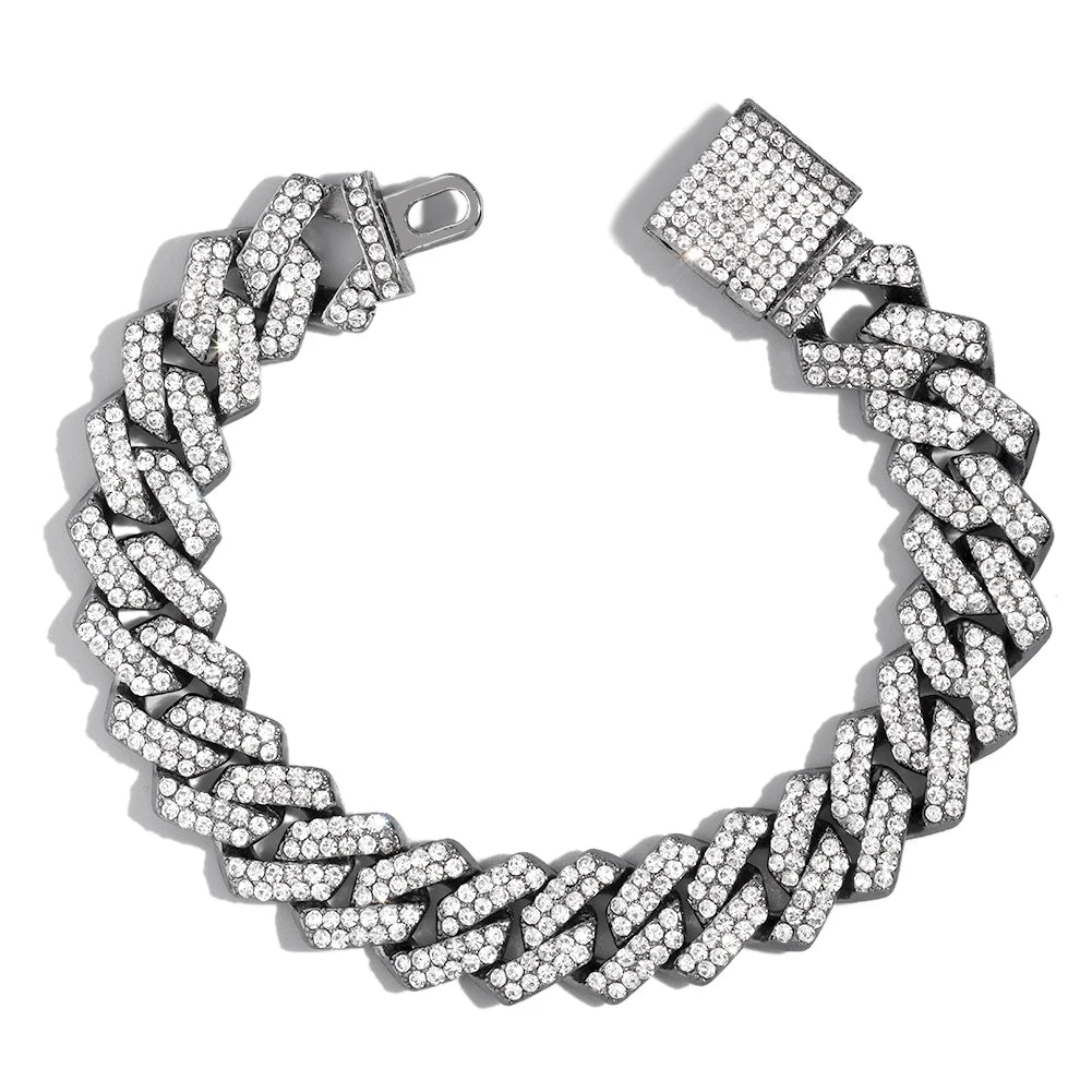 A silver iced-out Cuban link bracelet featuring rhinestone pavé stones.