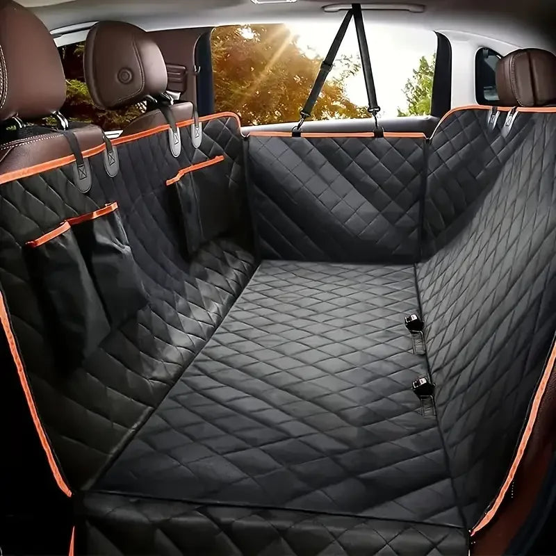 A view of a black quilted waterproof dog car seat cover hammock installed in the back seat of a vehicle.