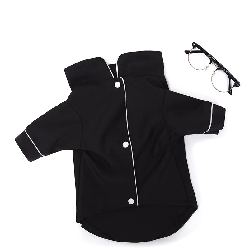 Black luxury silk pet pajamas for dogs displayed next to eyeglasses