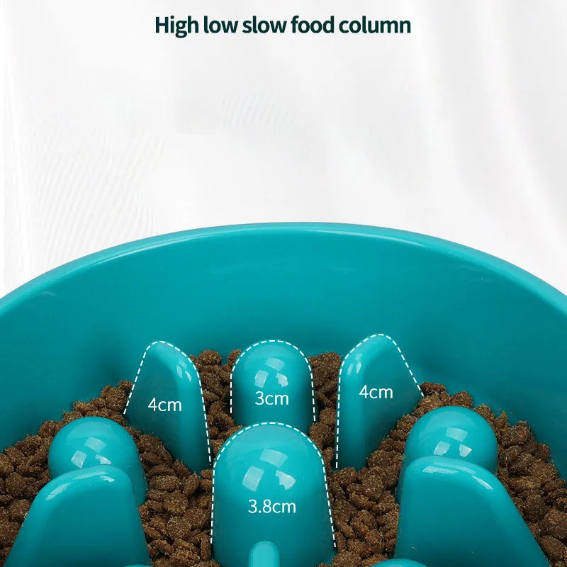 A blue slow food column puzzle feeder bowl filled with brown kibble.