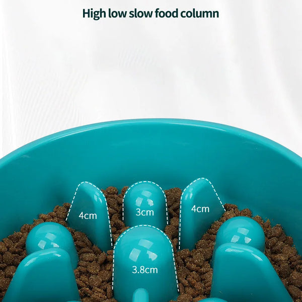 A blue slow food column puzzle feeder bowl filled with brown kibble.
